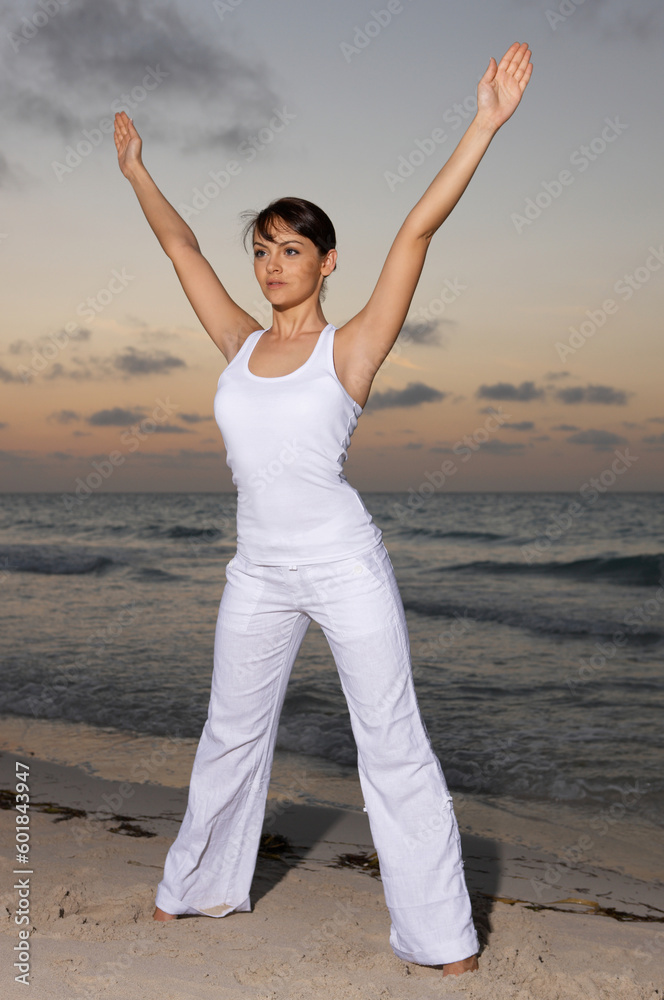 Young beautiful woman during fitness on sea beach Young beautiful woman during fitness on sea beach