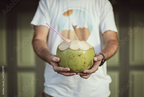 Close-up of a man holding a fresh coconut drink photo