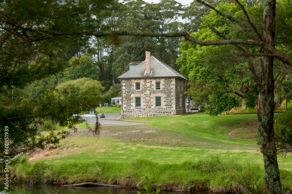 Old stone store framed by trees at Kerikeri