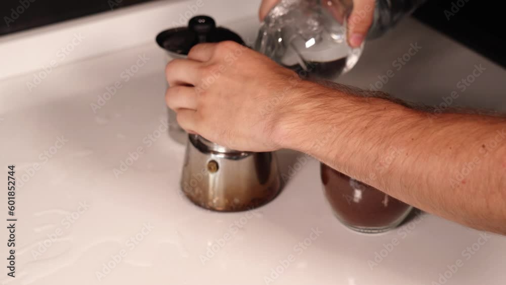 barista pours water and coffee into pot spilling on table barista pours water and coffee into pot spilling on table