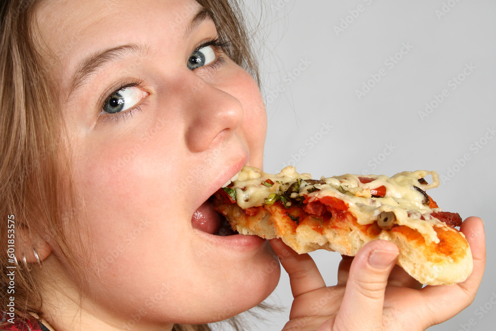 Beautiful no make-up girl eating a piece of Pizza Beautiful no make-up girl eating a piece of Pizza