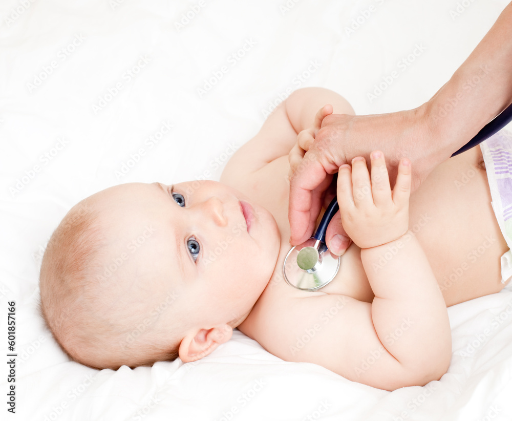 Children's doctor exams infant with stethoscope