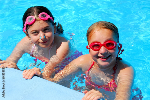 Two girls having fun in a swimming pool