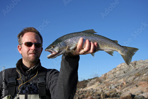 Fototapeta Naklejka Na Ścianę i Meble -  A man displaying a nice sea trout