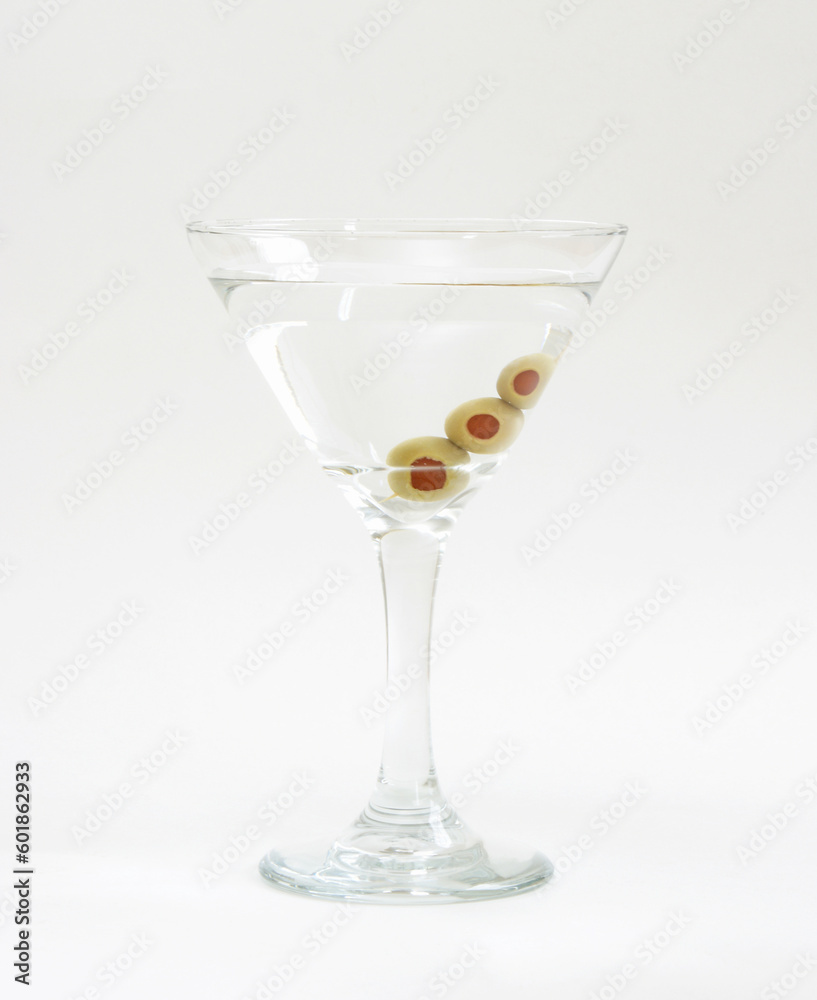 A vodka martini with three fresh olives inside. A vodka martini with three fresh olives inside.