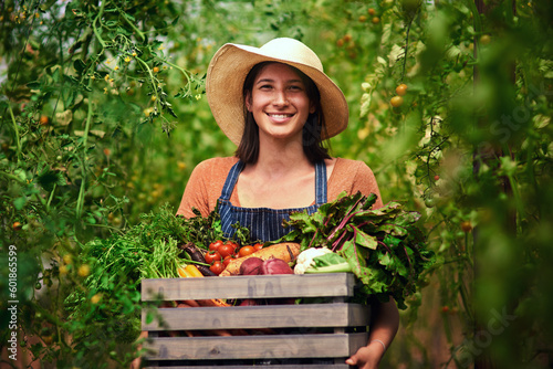 Farmer, agriculture and portrait of woman with crate on farm after harvest of summer vegetables. Farming, female person and smile with box of green product, food or agro in nature for sustainability photo