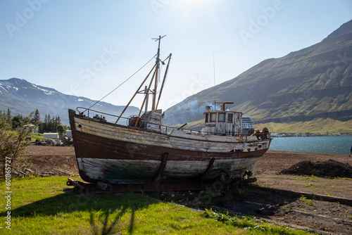 An abandoned ship in Iceland with mountains in the background