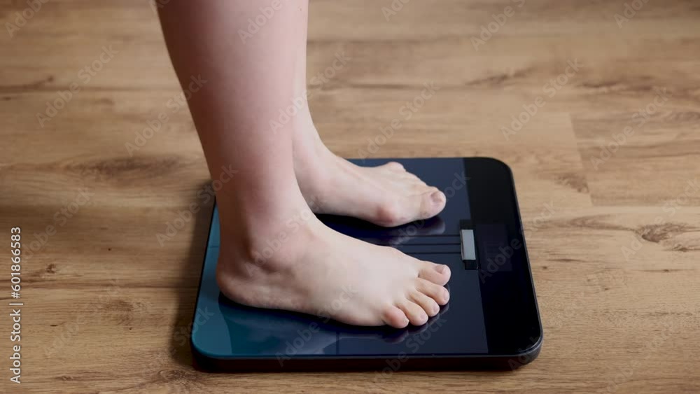woman stepping on body scale being shocked with weight.female with fat on belly and vegetables in plate.after childbirth recovery,get slim fit,diet concept.measure tape on neck,hands on face woman stepping on body scale being shocked with weight.female with fat on belly and vegetables in plate.after childbirth recovery,get slim fit,diet concept.measure tape on neck,hands on face