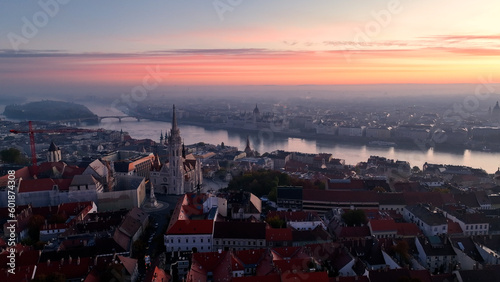 Budapest, Hungary, flying over the famous Fishermans Bastion and Matthias church towards the River Danube with Parliament of Hungary at background