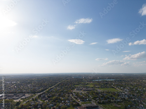Drone view, sun-drenched Brampton real estate, lush green yards, picturesque houses off Bramalea-Mayfield. Summer in Ontario at its best