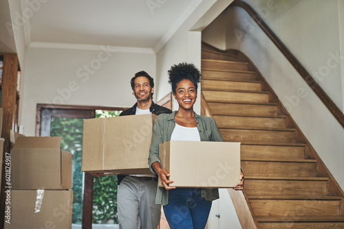 Happy couple, real estate and moving in new home with boxes for renovation, investment or relocation. Interracial man and woman owner carrying box for property rent, mortgage loan or move together photo