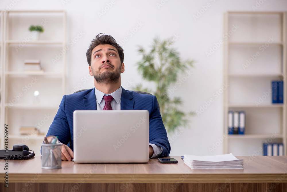 Young male employee working in the office Young male employee working in the office