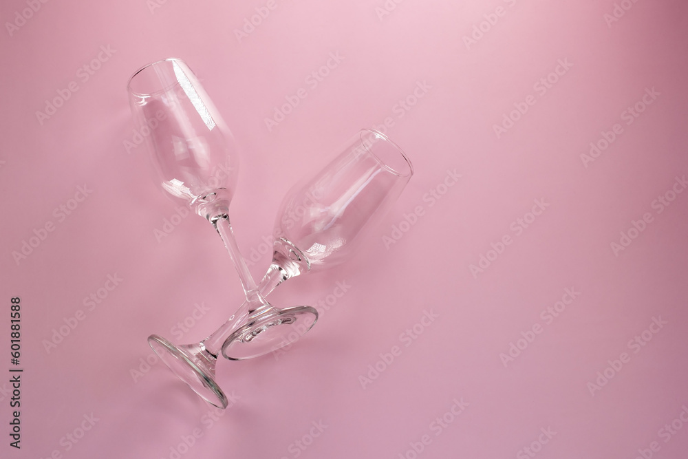 Two empty champagne glasses on a pink background, top view, copy space, flat lay Two empty champagne glasses on a pink background, top view, copy space, flat lay
