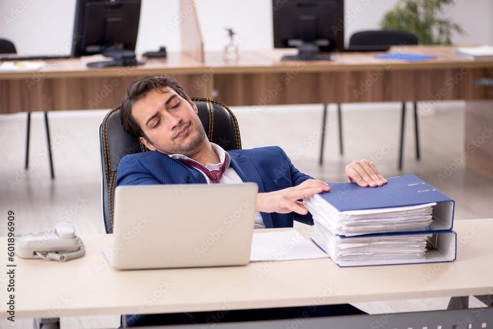 Young male employee working in the office Young male employee working in the office