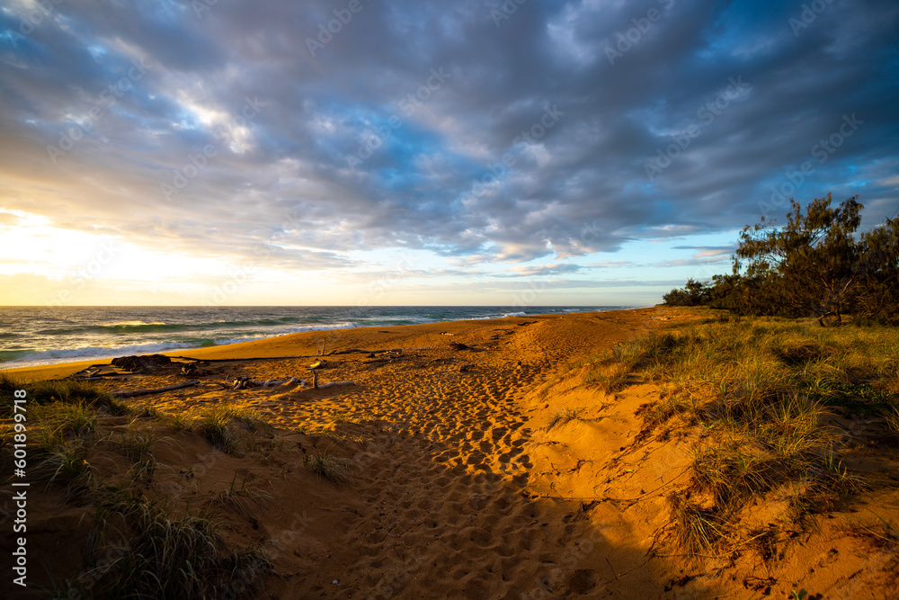 colorful sunrise on the wreck rock beach in deepwater national park near agnes water and town of 1770, gladstone region in queensland, australia; rural australia landscape, red sand beach colorful sunrise on the wreck rock beach in deepwater national park near agnes water and town of 1770, gladstone region in queensland, australia; rural australia landscape, red sand beach