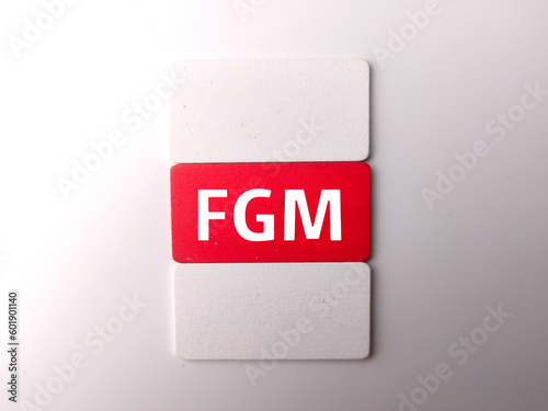 Colored wooden board with the word FGM