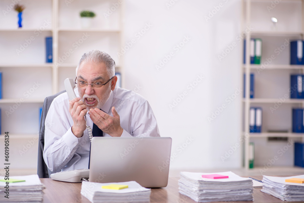 Old male employee and too much work in the office Old male employee and too much work in the office