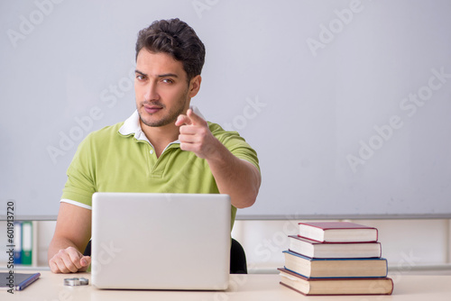 Young male student in telestudying concept photo