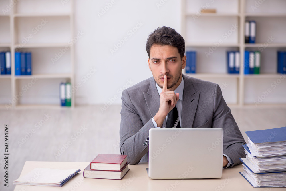 Young male employee working in the office Young male employee working in the office
