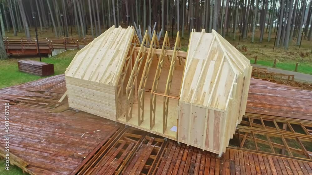 Drone flight from a platform with a timber frame of a house under construction. Drone flight from a platform with a timber frame of a house under construction.