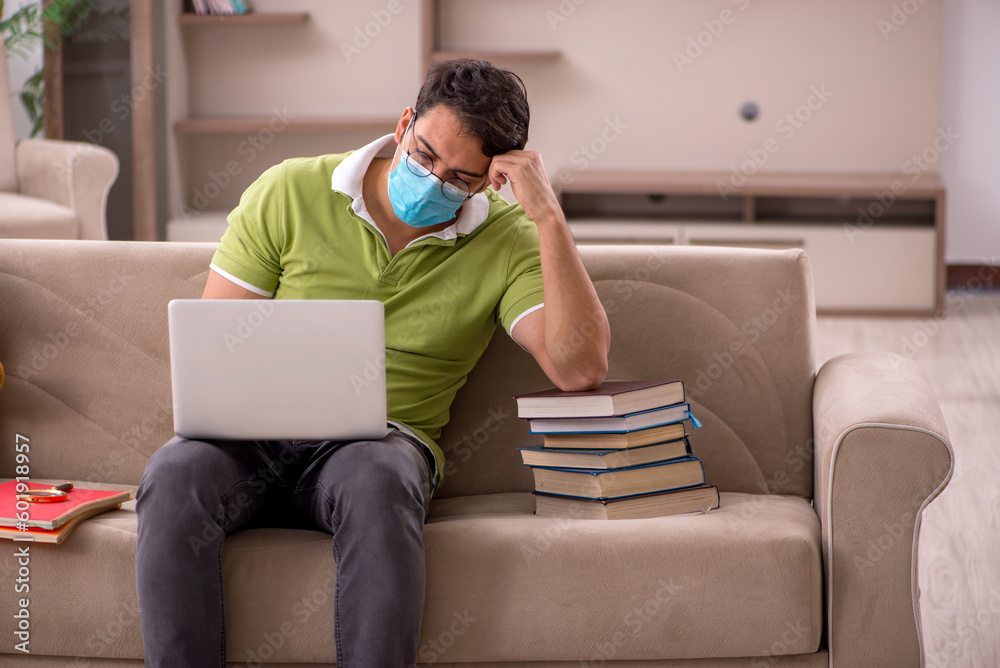 Young male student preparing for exams at home during pandemic Young male student preparing for exams at home during pandemic