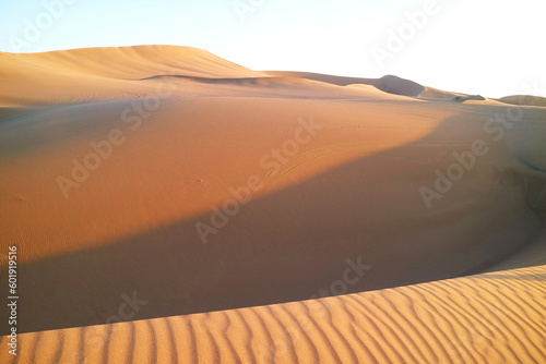 Fototapeta Naklejka Na Ścianę i Meble -  Vast sand dunes with beautiful sand ripples in the sunlight at Huacachina desert, Ica region, Peru, South America