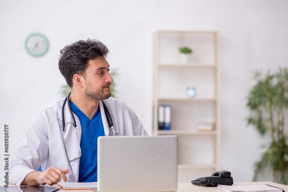 Young male doctor working in the clinic Young male doctor working in the clinic