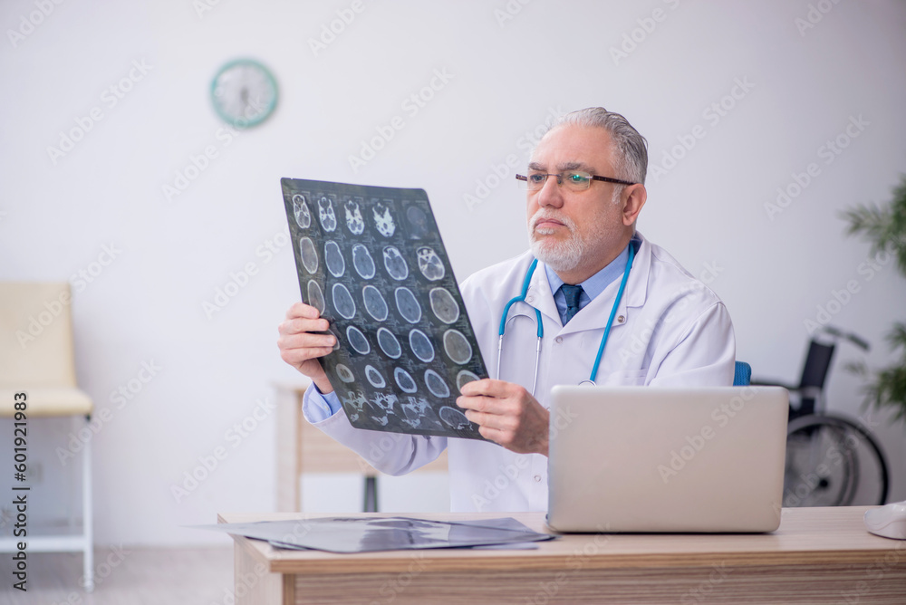 Old male doctor radiologist working in the clinic Old male doctor radiologist working in the clinic