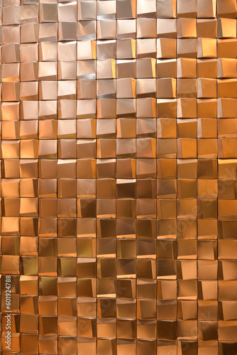 テクスチャ― 金色の凹凸のあるタイルの壁面texture of golden sqare tiles