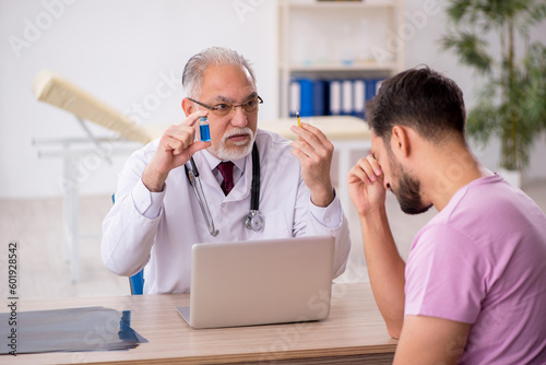 Young male patient visiting old male doctor