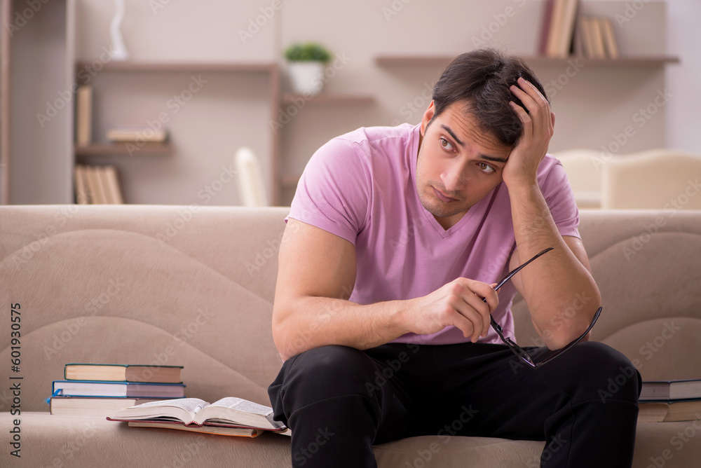 Young male student preparing for exams at home Young male student preparing for exams at home