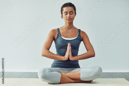 Yoga, meditation and calm woman on mat for wellness, breathing exercise and healthy body in studio. Fitness, spiritual and female person meditating for zen, peace and relax for balance and wellbeing