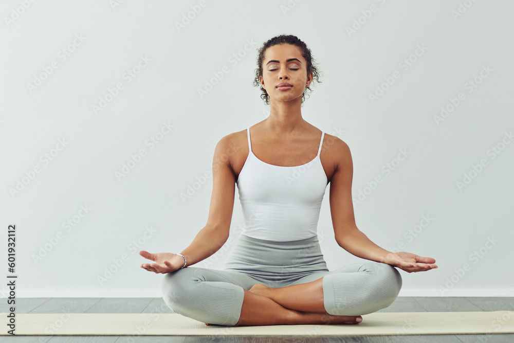 Yoga, meditation and woman on mat for wellness, breathing exercise and healthy body in studio. Fitness, spiritual zen and female person meditating for calm, peace and relax for balance and wellbeing