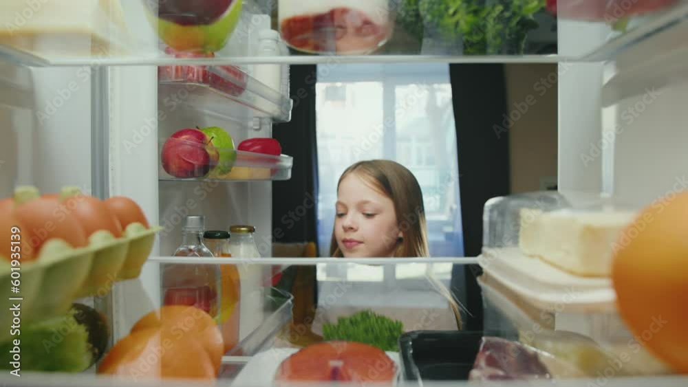 Young Girl Opening Fridge Door with Healthy Food and Taking Products. One Hungry Child Choosing Ingredients of Filled Refrigerator to Cooking Meal. Small Happy Kid Selecting Storing Groceries to Eat Young Girl Opening Fridge Door with Healthy Food and Taking Products. One Hungry Child Choosing Ingredients of Filled Refrigerator to Cooking Meal. Small Happy Kid Selecting Storing Groceries to Eat