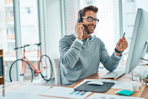 Call center, man and consultant consulting with a smile doing internet telemarketing sales in an agency office. Young, computer and happy male employee working on customer service for support