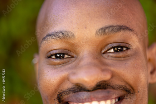 Closeup portrait of african american young man with black eyes smiling