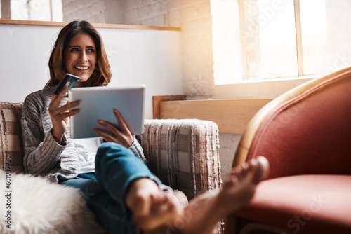 Thinking, tablet and credit card with an ecommerce woman on a sofa in the living room of her home. Online shopping, finance and fintech banking with a young female online customer in her house
