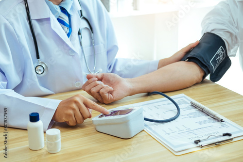 Doctor Measuring arterial blood pressure with man patient on arm Health care in hospital