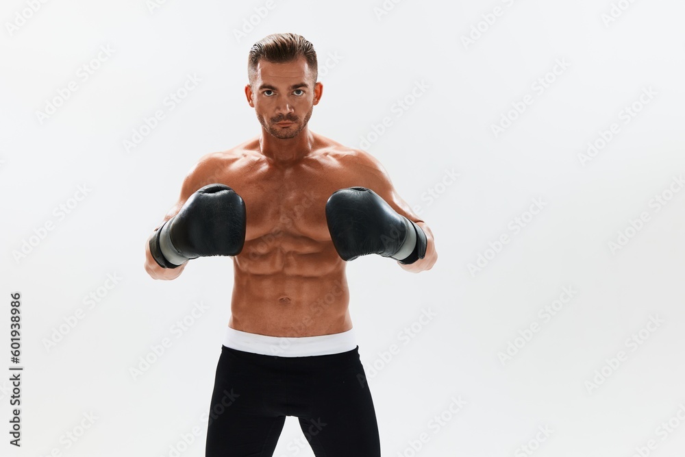 Man athletic bodybuilder poses in boxing gloves with nude torso abs in full-length background, boxing and martial arts. Advertising, sports, active lifestyle, competition, challenge concept. Man athletic bodybuilder poses in boxing gloves with nude torso abs in full-length background, boxing and martial arts. Advertising, sports, active lifestyle, competition, challenge concept.
