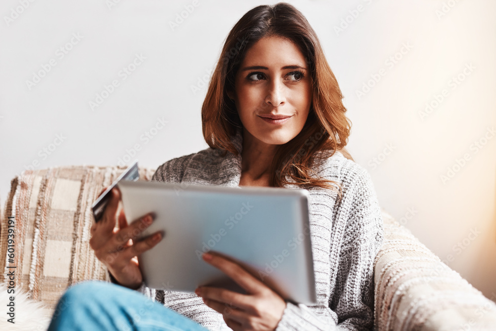 Idea, tablet and online customer with a woman shopping using a credit card on a sofa in the living room at home. Ecommerce, finance and internet banking with a young female shopper in her house Idea, tablet and online customer with a woman shopping using a credit card on a sofa in the living room at home. Ecommerce, finance and internet banking with a young female shopper in her house