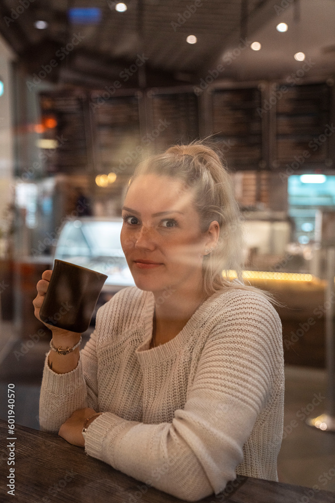 woman drinking coffee in cafe