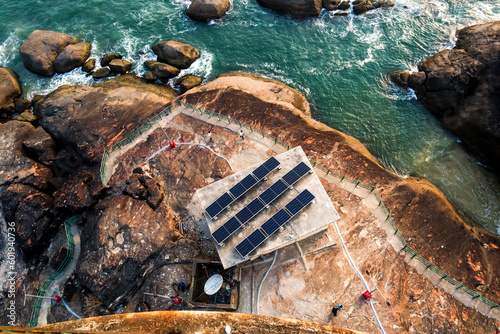 the aerial landscape image of sea and rocks with small solar plant