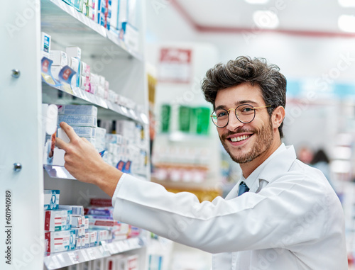 Pharmacist, medicine and portrait of a man working in a pharmacy store for retail career with a smile. Male person in pharmaceutical or medical industry for service, healthcare and inventory on shelf