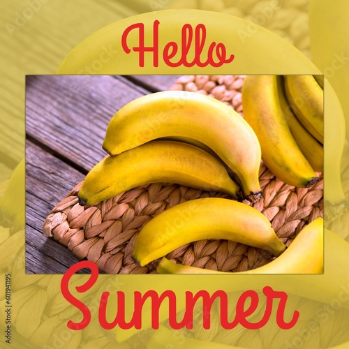 Composite of hello summer text and fresh bananas on wooden table, copy space