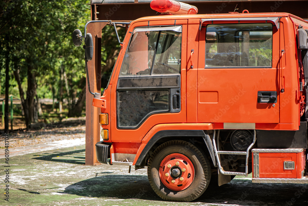 Obraz premium The golden rays of sunlight enhanced the vibrant red color of the fire engine serving as a reminder of the brave firefighters who stand ready to battle the forces of fire and ensure the safety.