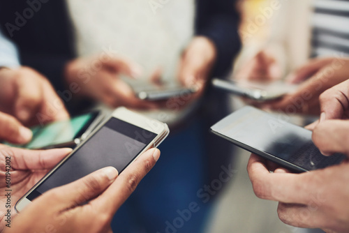 Business people, phone and hands for communication, networking or social media together at office. Hand of group holding mobile smartphone in connection, data sync or sharing information at workplace
