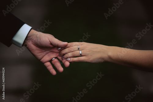 Bride and groom holding hands, Strong partnership bond. Love and lovemaking.