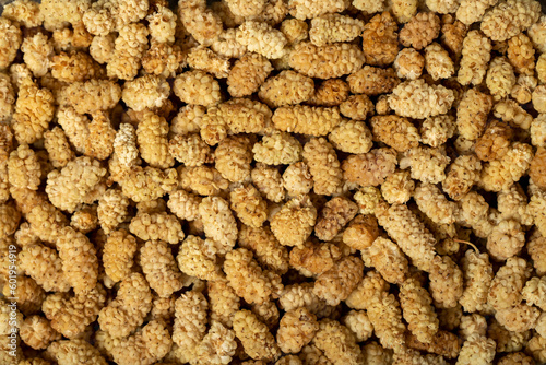 Dried mulberry. Dried white mulberry fruits closeup food background. Top view. texture. copy space banner
