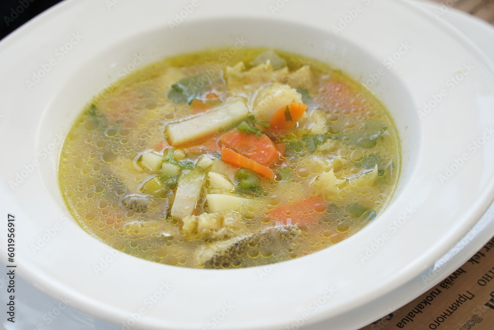 Psarosoupa - fish soup, traditional to Greek cuisine. Soup with white fish in a greek taverna Psarosoupa - fish soup, traditional to Greek cuisine. Soup with white fish in a greek taverna