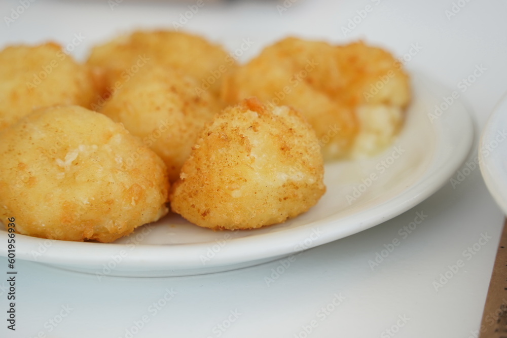 Round panned and fried cheese balls filled with mozzarella